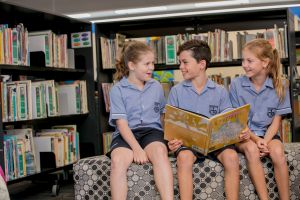 Students reading together in a library setting promoting engagement with books and collaborative learning