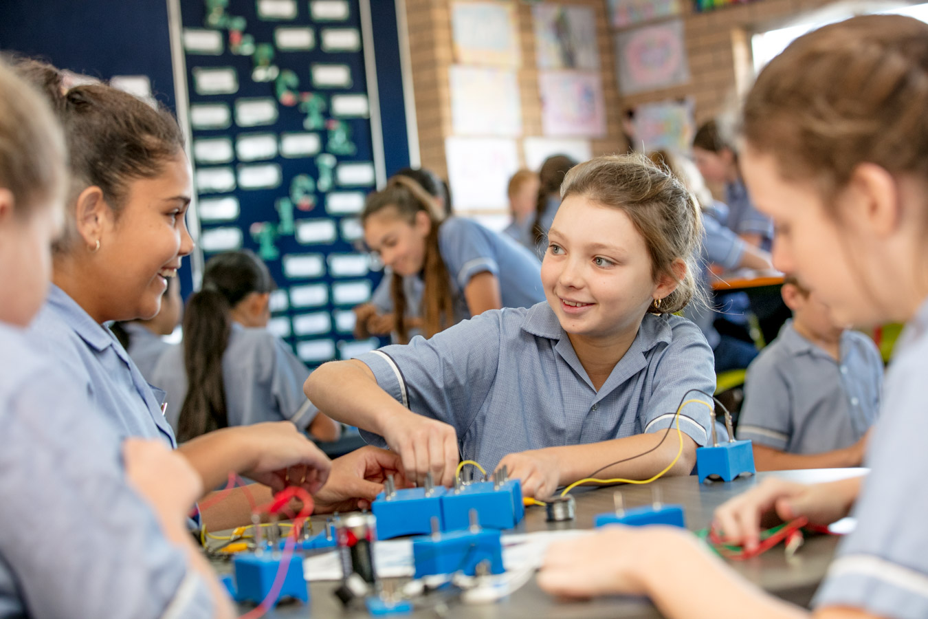 Students working together on a hands on electrical circuit activity in a classroom supporting collaboration problem solving and practical STEM learning