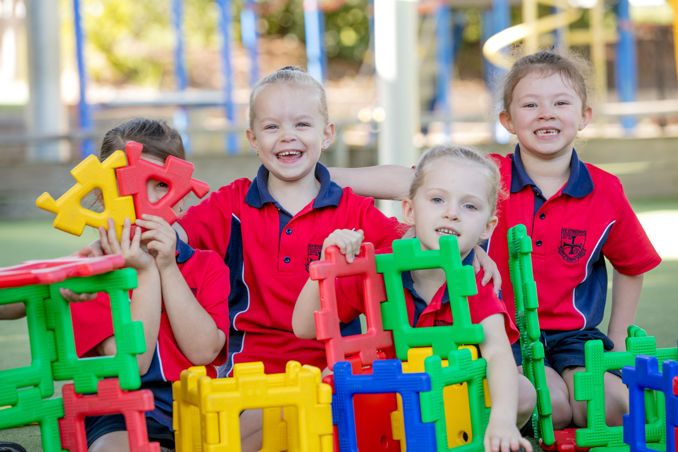 Students building with large colourful construction blocks outdoors promoting creativity collaboration and active play Provide your feedback on BizChat