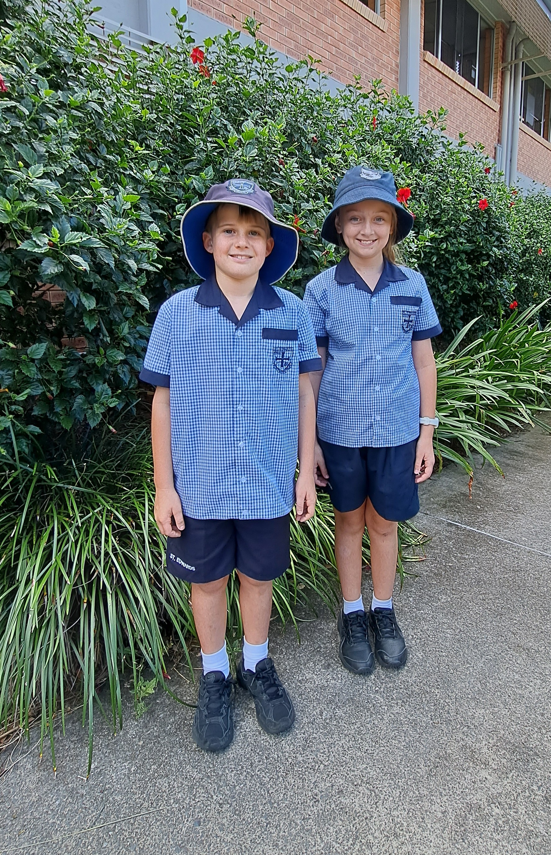 Students in school uniform standing outdoors together highlighting school identity belonging and a welcoming campus environment