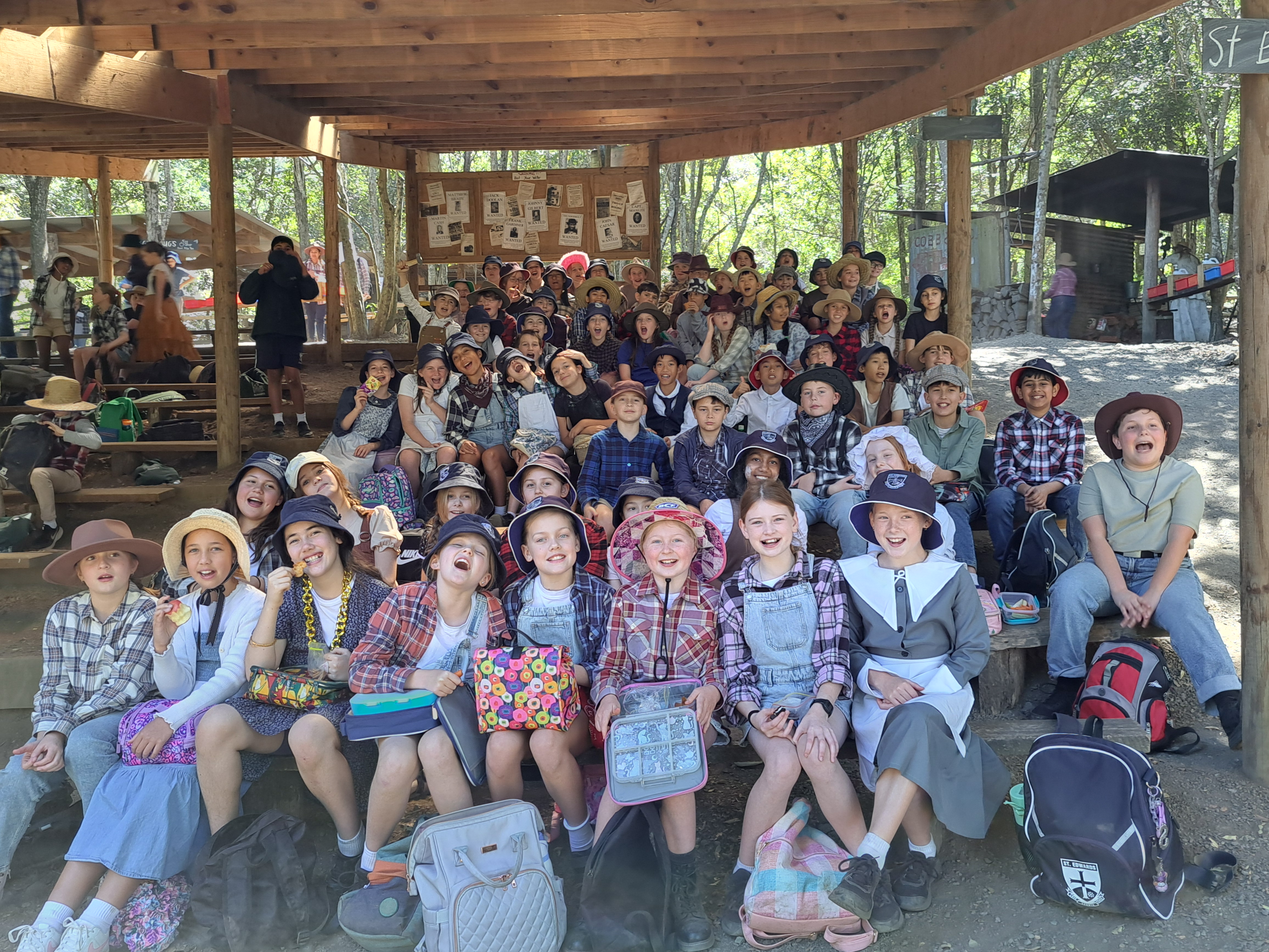 Students gathered together in outdoor bush setting during a school excursion highlighting community connection collaboration and experiential learning