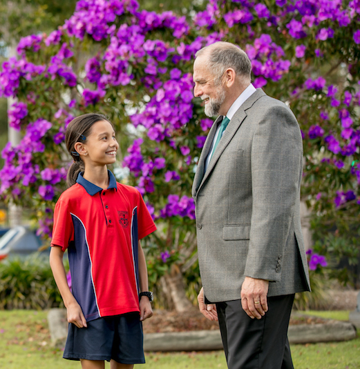 St Edward the Confessor Catholic School principal and student standing outdoors together highlighting positive relationships leadership and a supportive school community