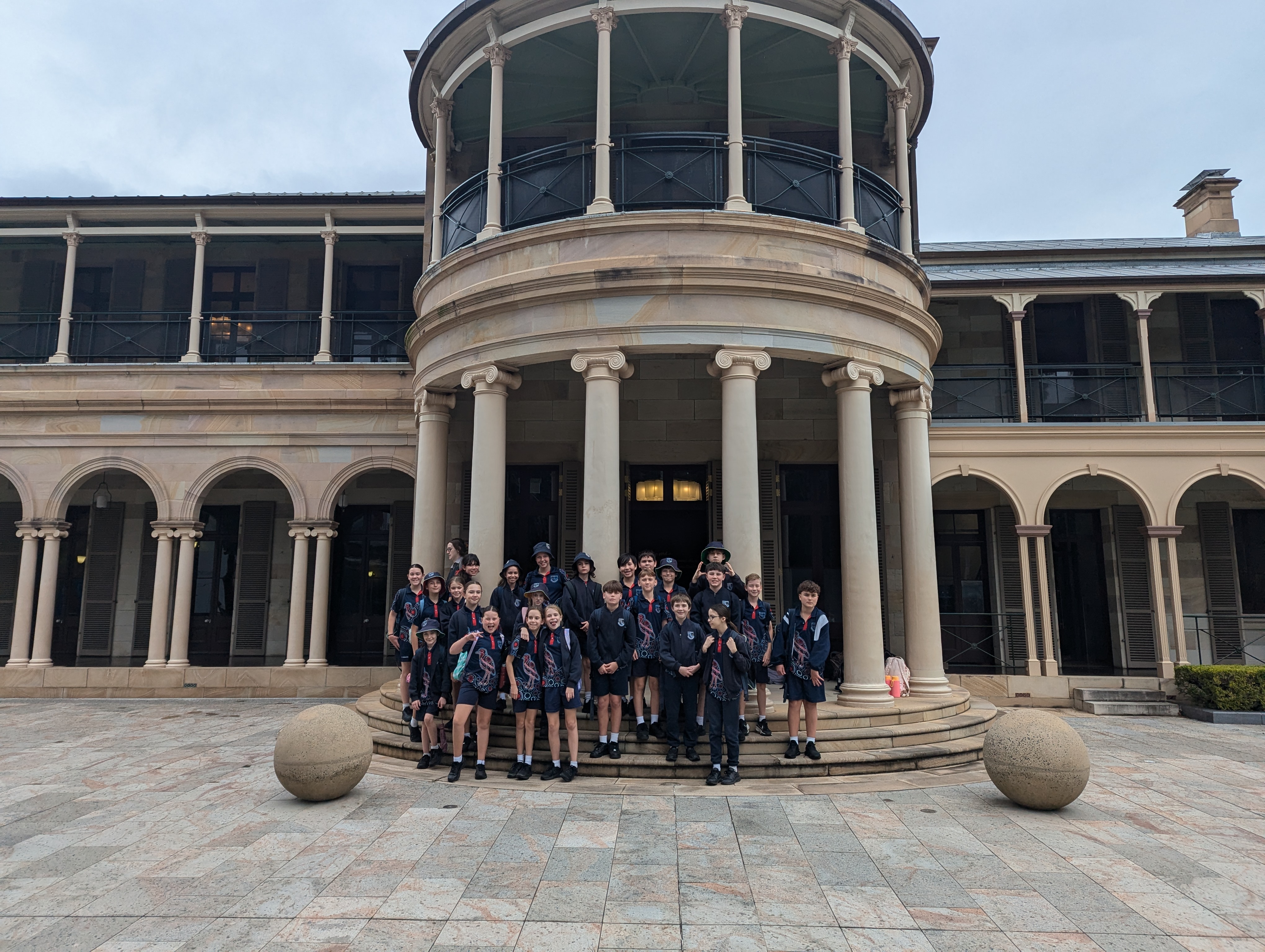 Year 6 students gathered on the steps outside Parliament House highlighting an educational excursion focused on civic learning government and real world experiences