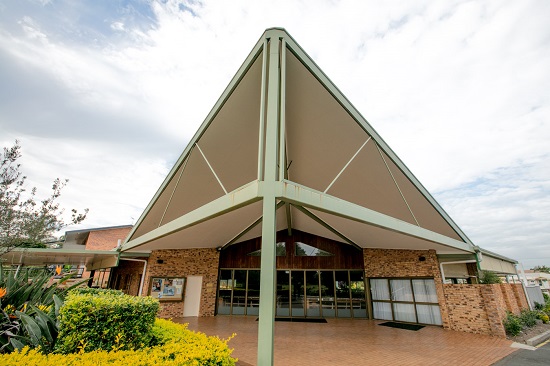 School building with covered entrance and distinctive architectural design showcasing a welcoming and functional learning environment